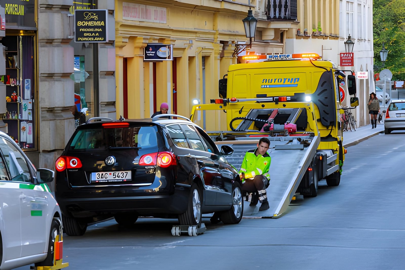 The car is loaded on an evacuation tow truck in the city