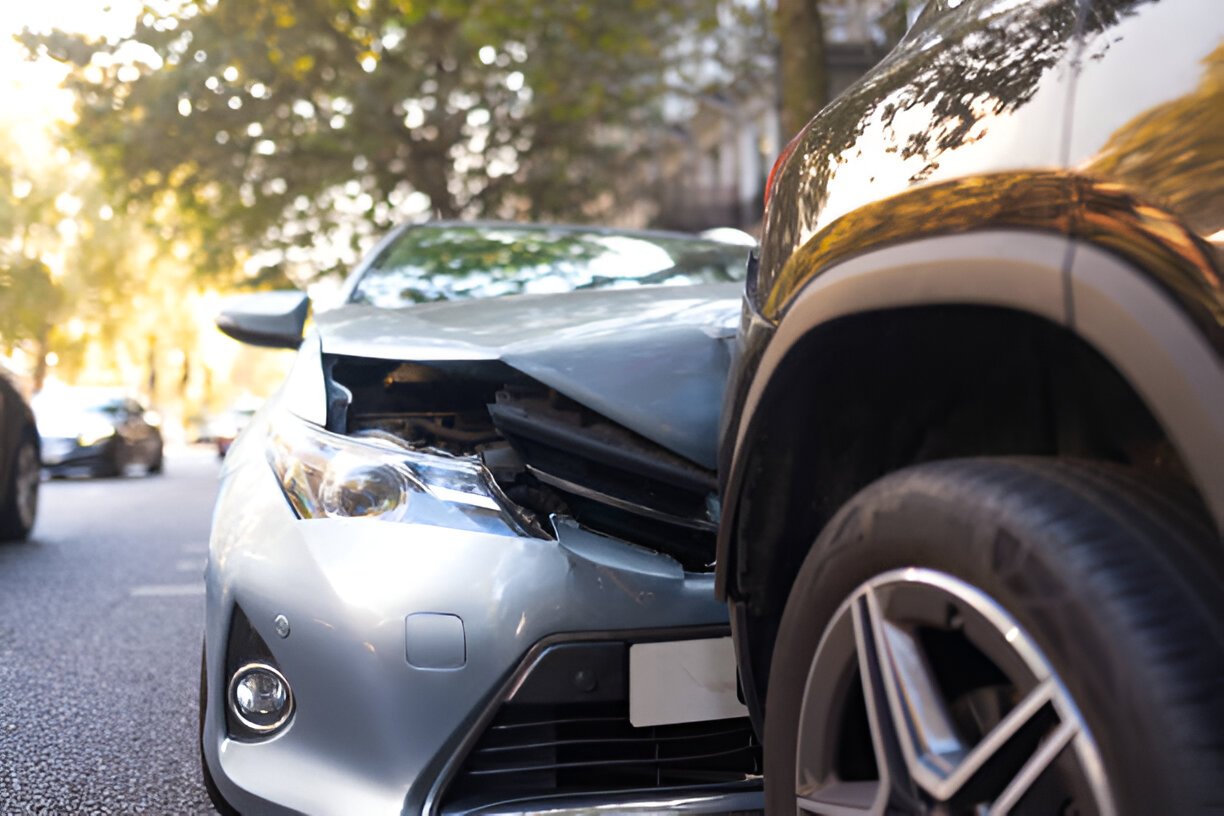 Two damaged vehicles in car accident after collision on city street.